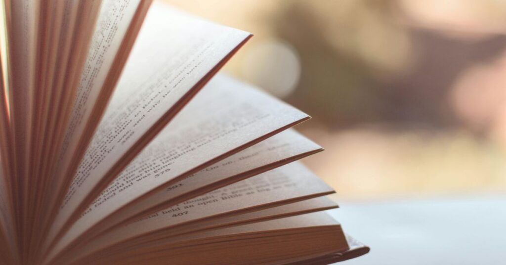 Open book with softly lit pages, reflecting the calm and thoughtful mood of All the Broken Places